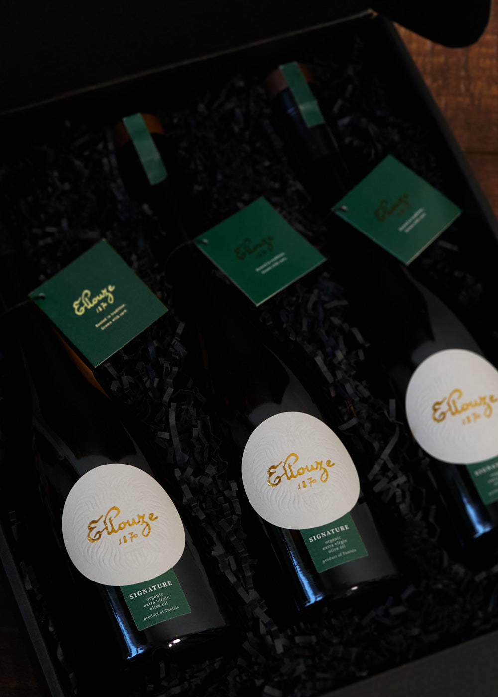 Ellouze 1870 Signature Organic Extra Virgin Olive Oil 500ml bottles beautifully arranged in a black gift box with green tags