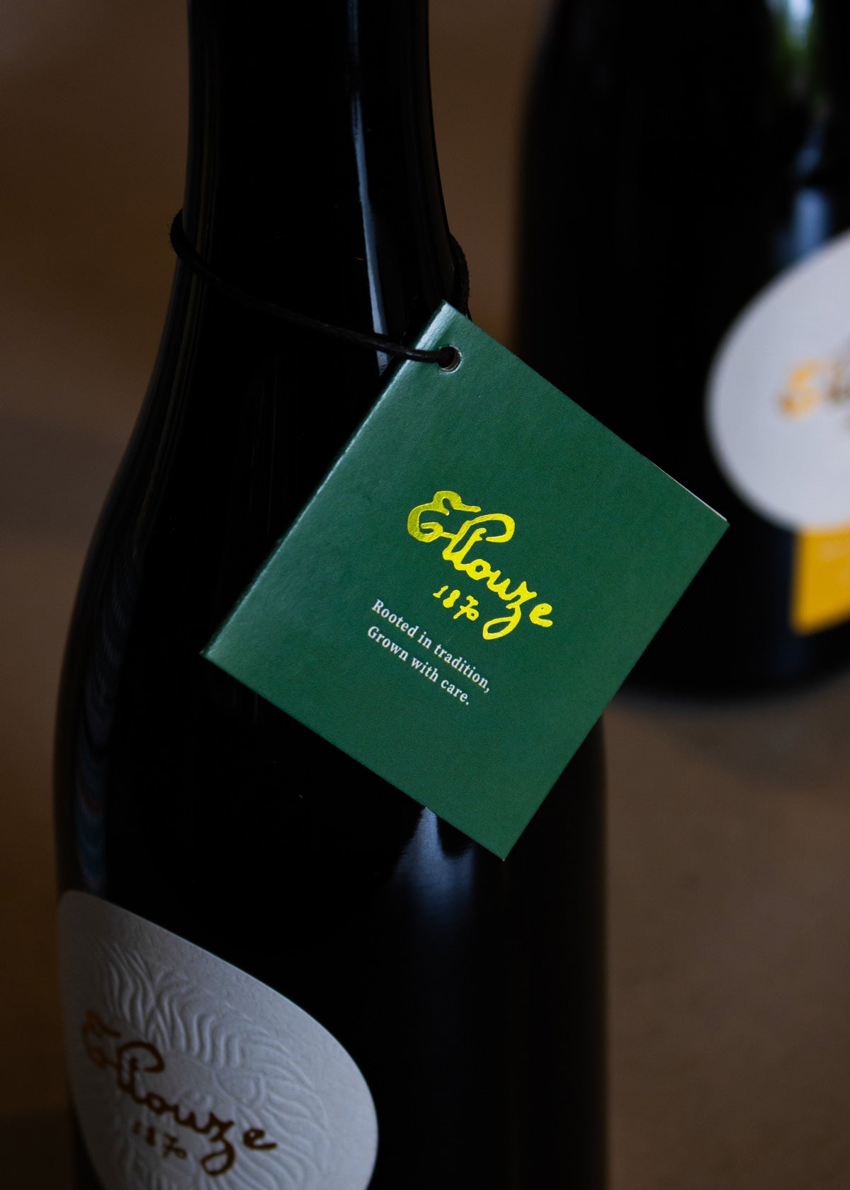 Close-up of Ellouze 1870 Signature Organic Extra Virgin Olive Oil 500ml Bottle with Green Tag Displaying Logo